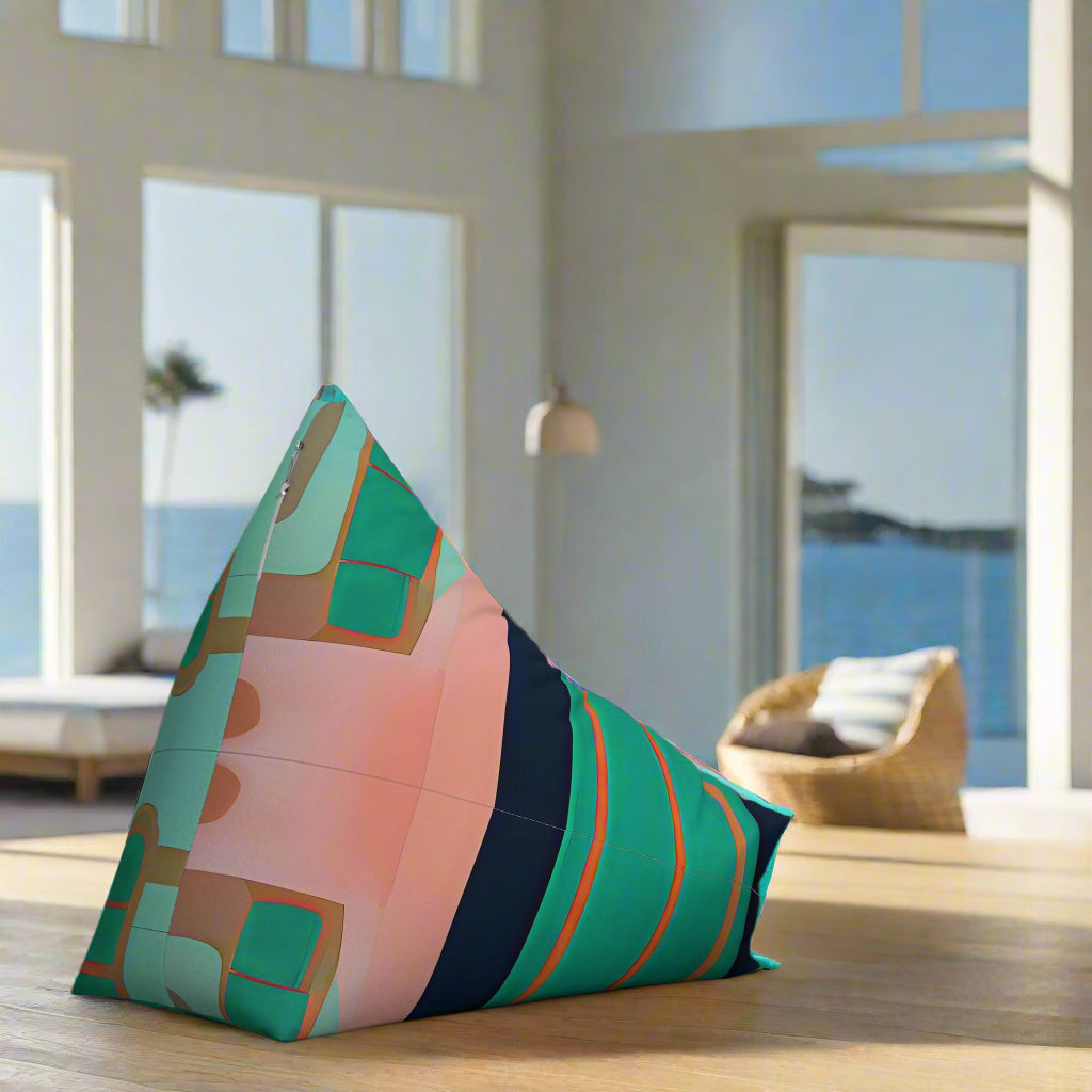 Rear of colourful pink green and navy bean bag shown, sits in a light filled beach house