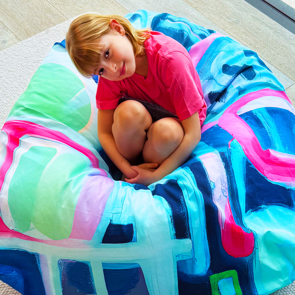 Child lounging on Flow State designer bean bag cover from Bean Bag Lab.